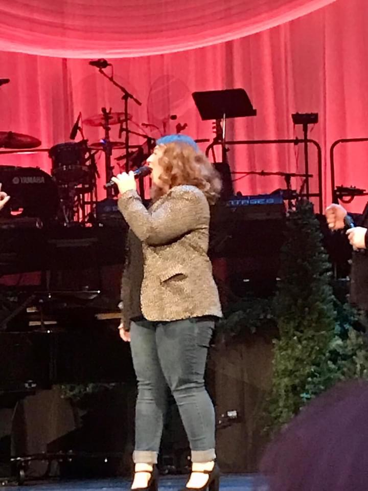 Caitlyn singing on stage